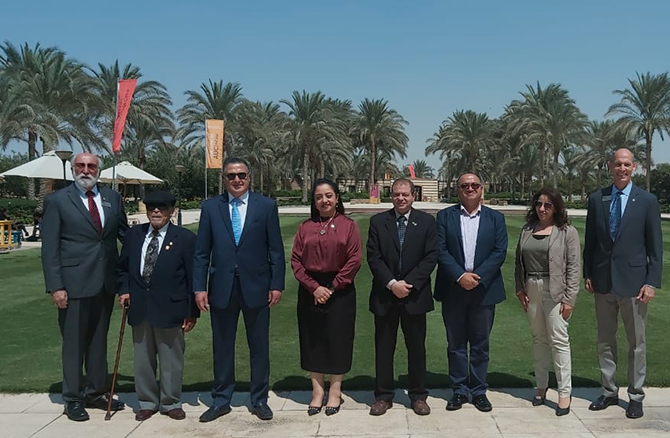 ASCE and ASCE Egypt Section Leaders met in Cairo, Egypt on September 2022. Pictured are eight people standing outside smiling in front of Cairo University on a sunny day.