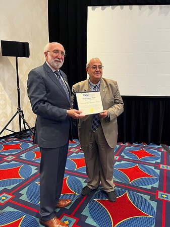 President Truax and Dr. Elias at the Global Reception of the ASCE 2022 Convention. Pictures are 2 people standing holding an award smiling at the camera