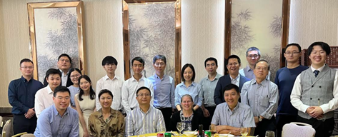 Greater China Section welcome dinner. Pictured are 20 people behind a table smiling at the camera. 