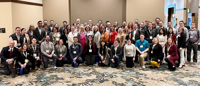 2023 MRLC Regions 3,6,7 Denver, Colorado group photo. Pictured 63 people facing the camera smiling in a hallway. 