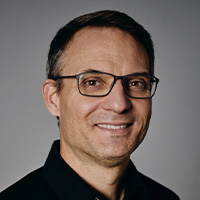 Man in suit smiles at the camera