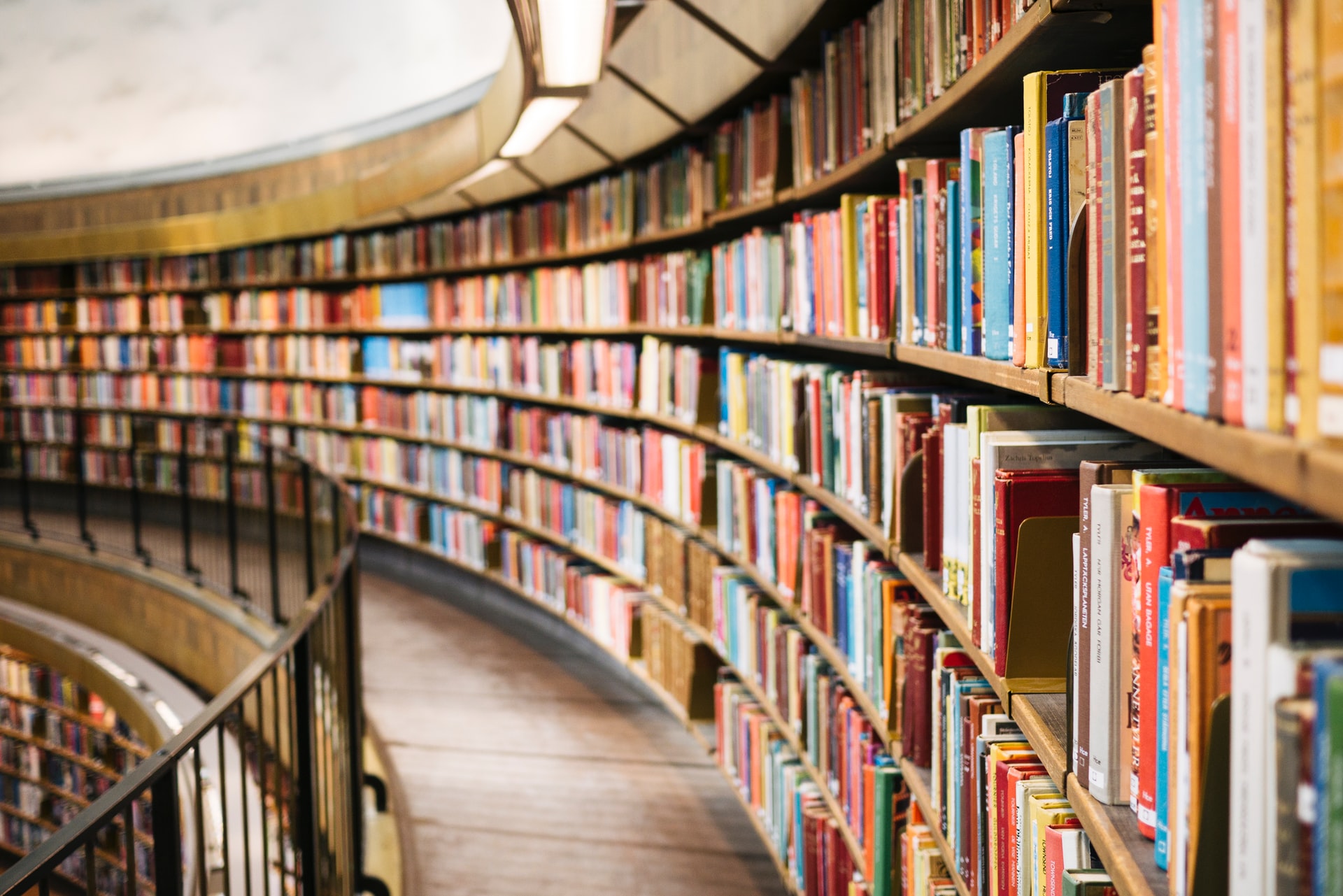 the curved balcony of a well-stocked bookstore curves away from the viewer