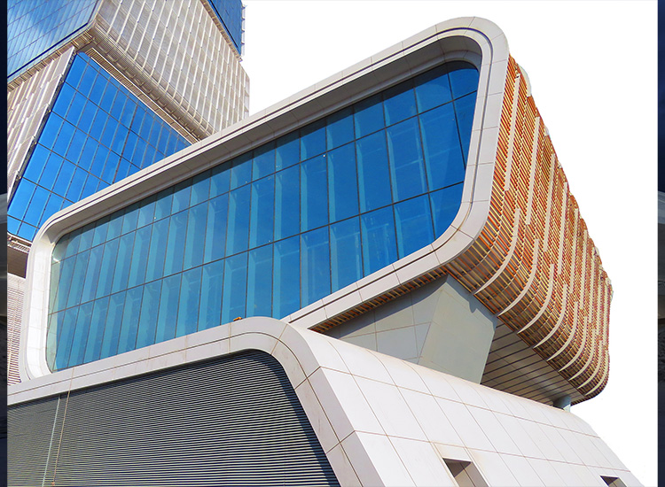 Image shows part of an auditorium with multistory glass windows. 