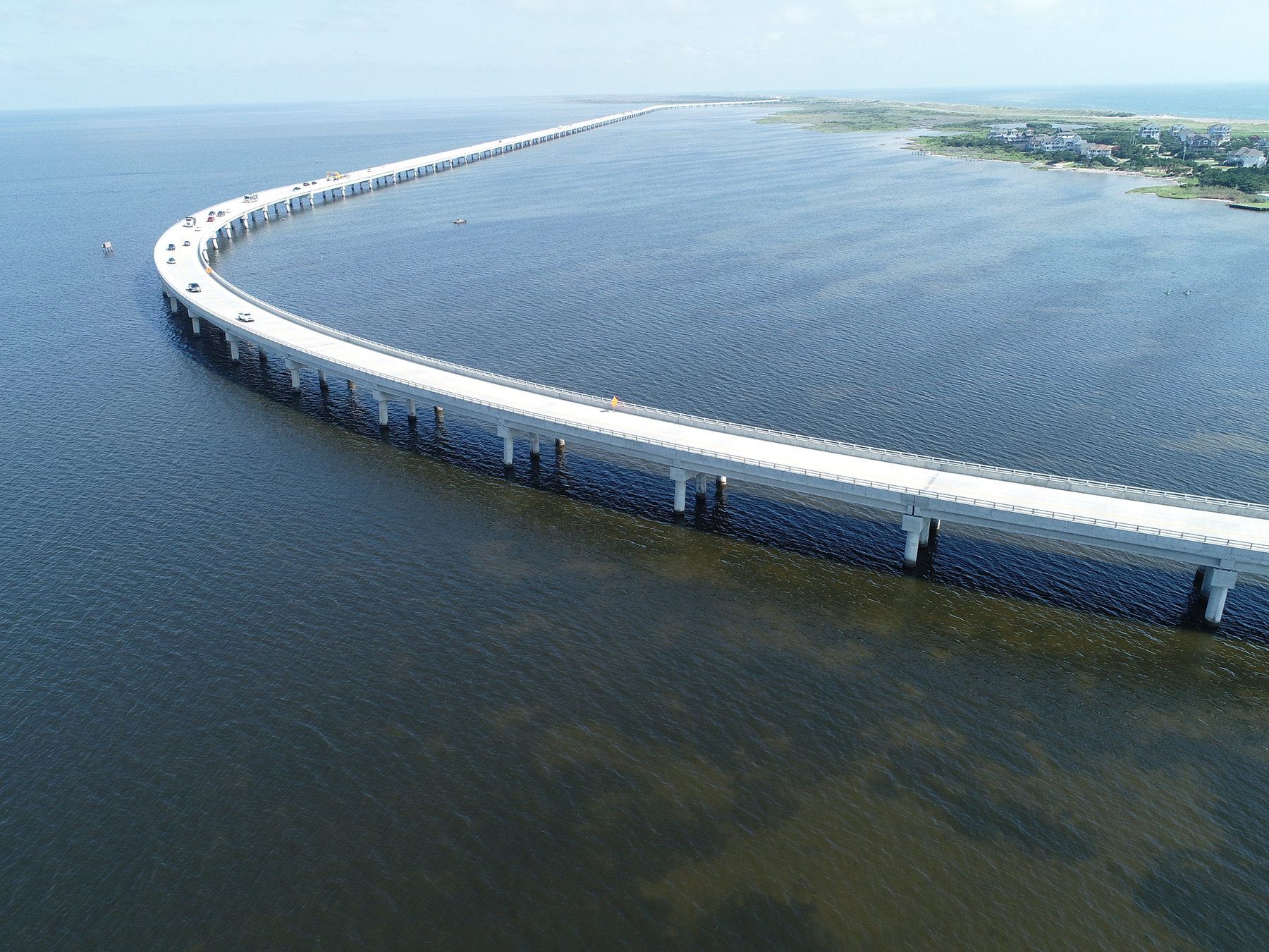 Uniquely shaped bridge curves over a large body of water.