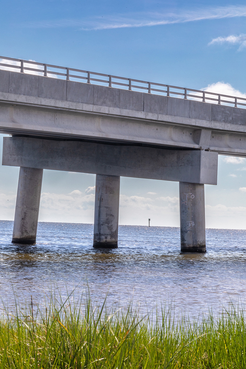 Image shows bridge piers in water.