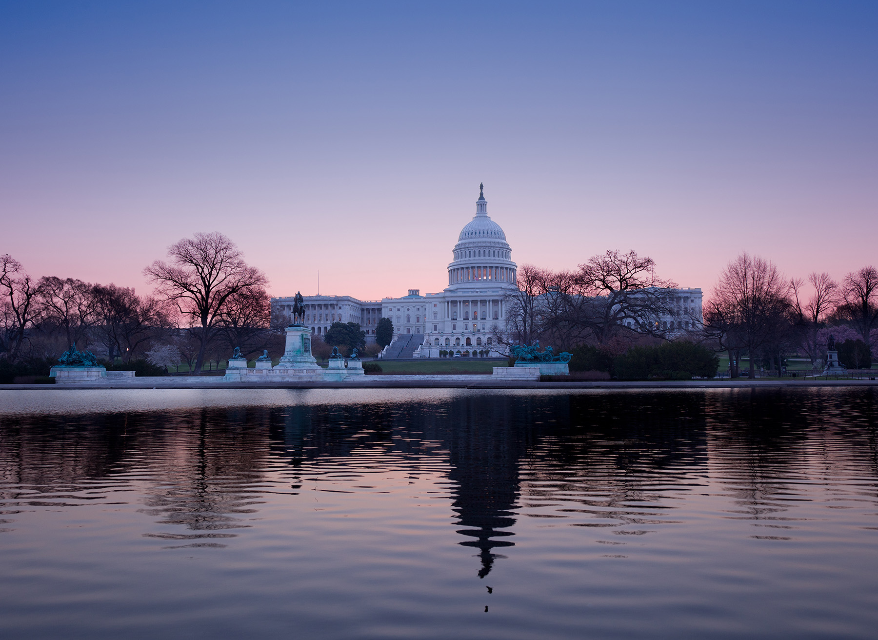 Photo shows the back of the U.S. Capitol building at dusk.
