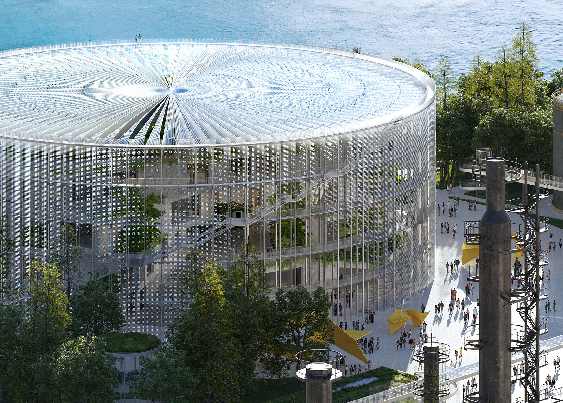 A large circular structure with floor-to-ceiling windows sits amid a large park. 