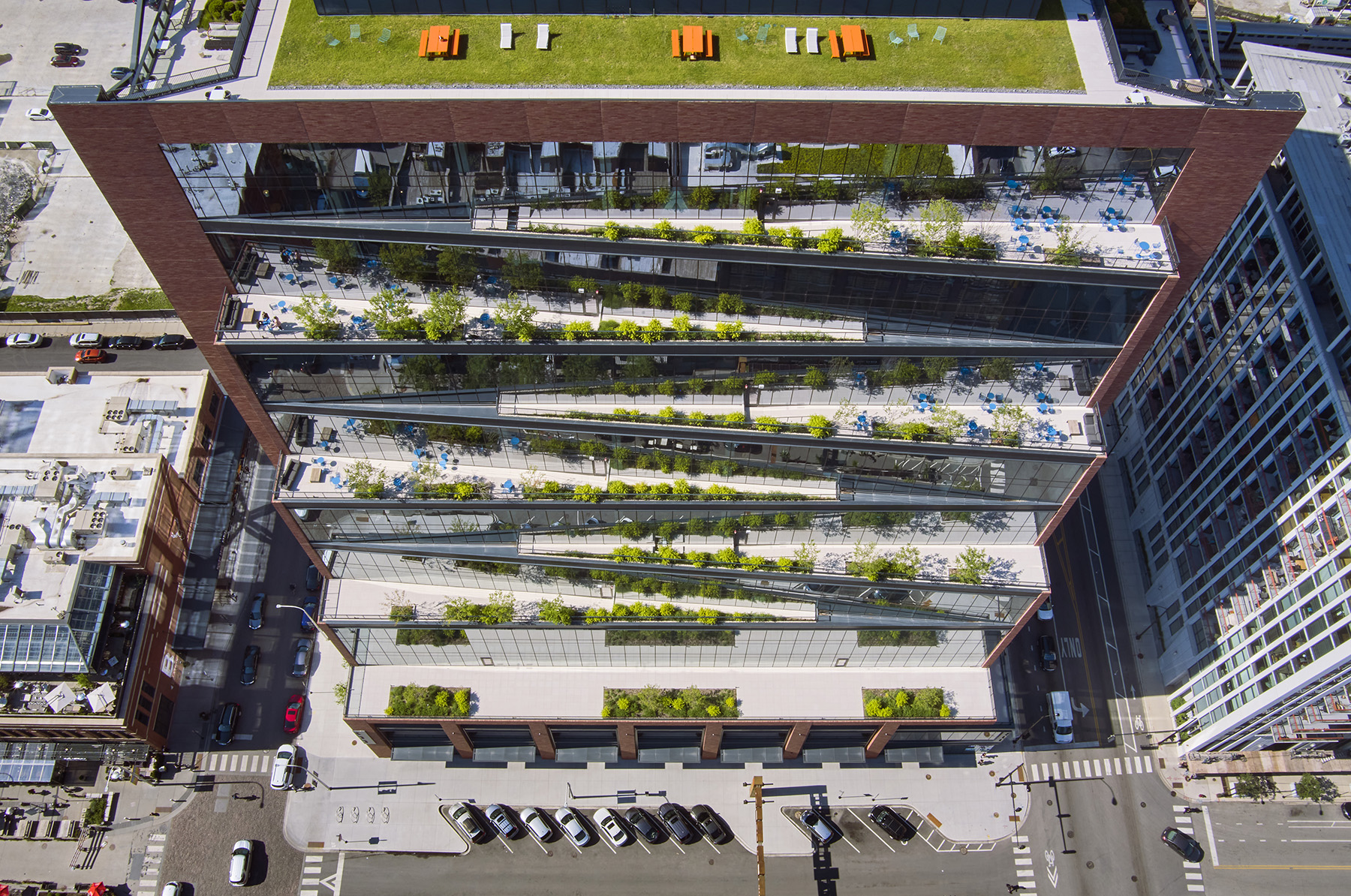 The image shows a green roof and green terraces on the top and side of a building.
