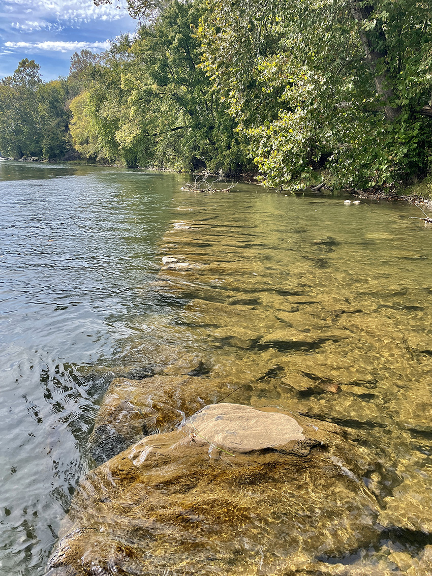 Photo shows a wall made of overlapping stones built to divert water. 