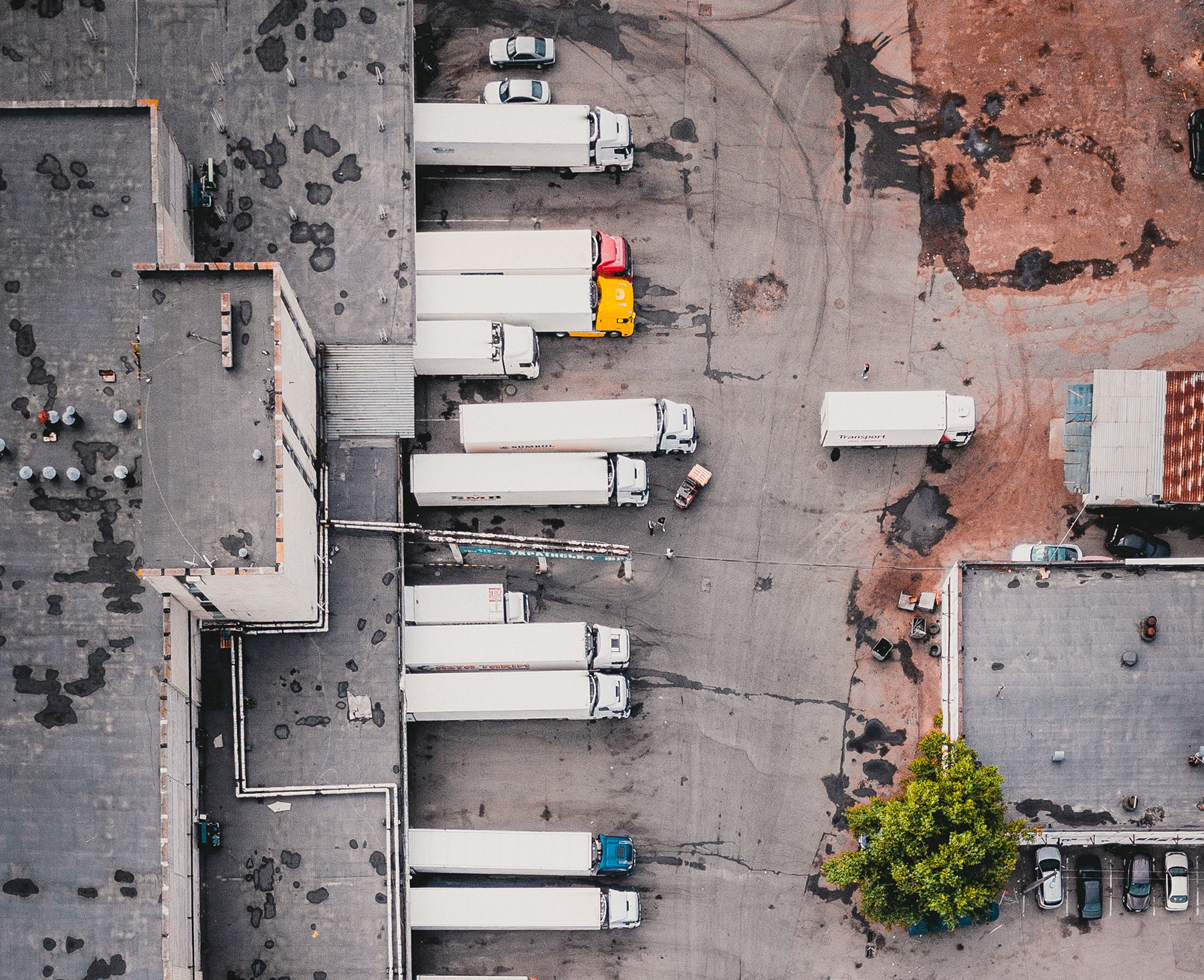 AERIAL OF PARKED TRUCKS AT WAREHOUSE