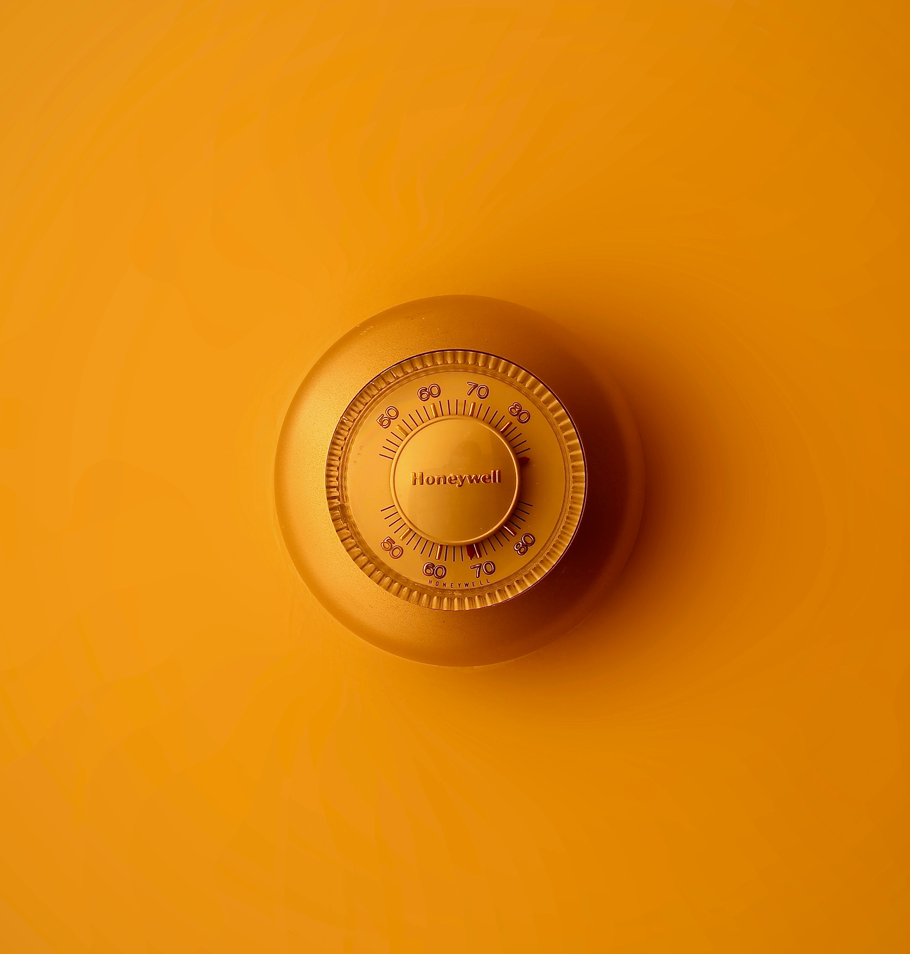 ORANGE THERMOSTAT ON ORANGE BACKGROUND