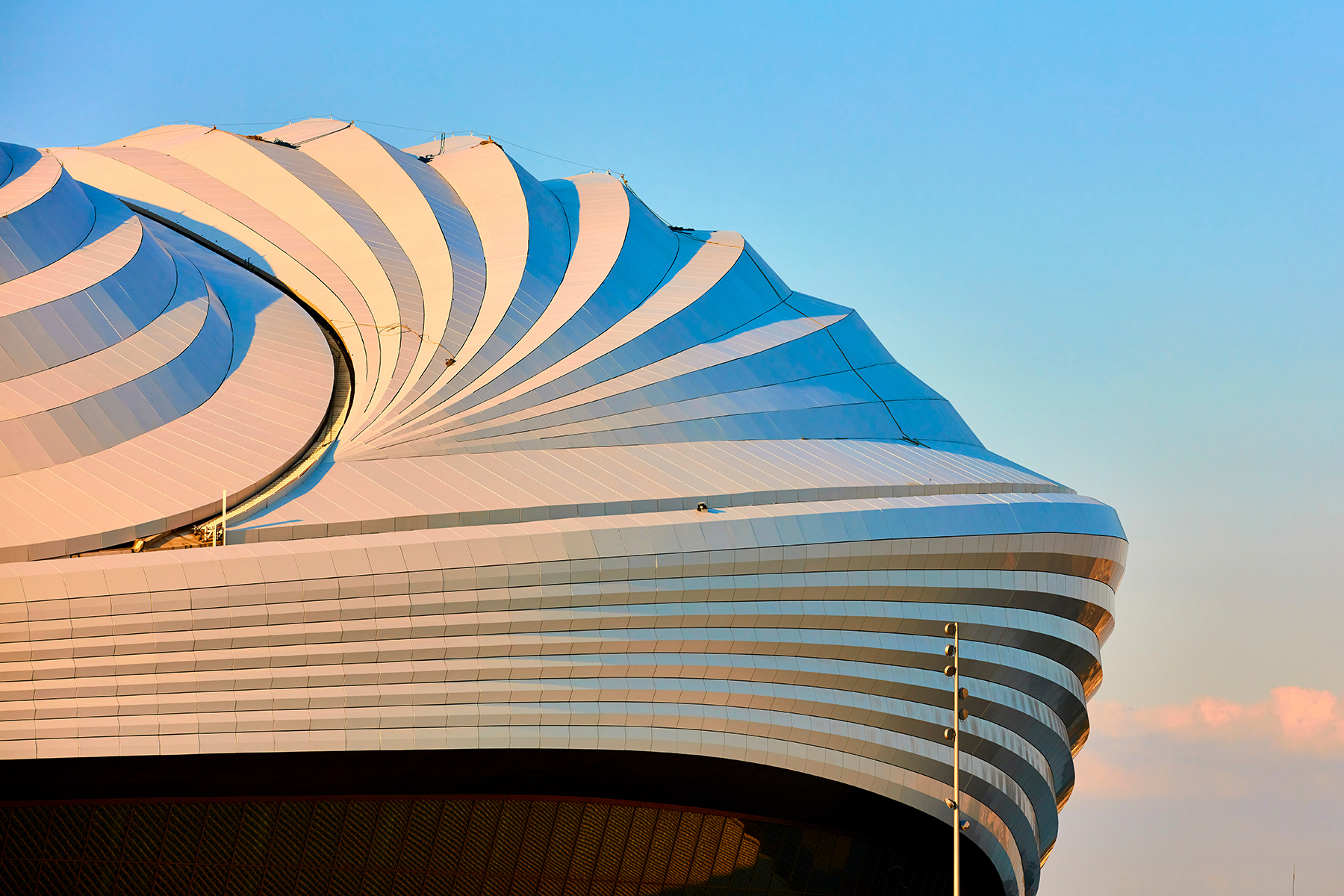 The photograph shows a detail of the roof of the Al Janoub Stadium.