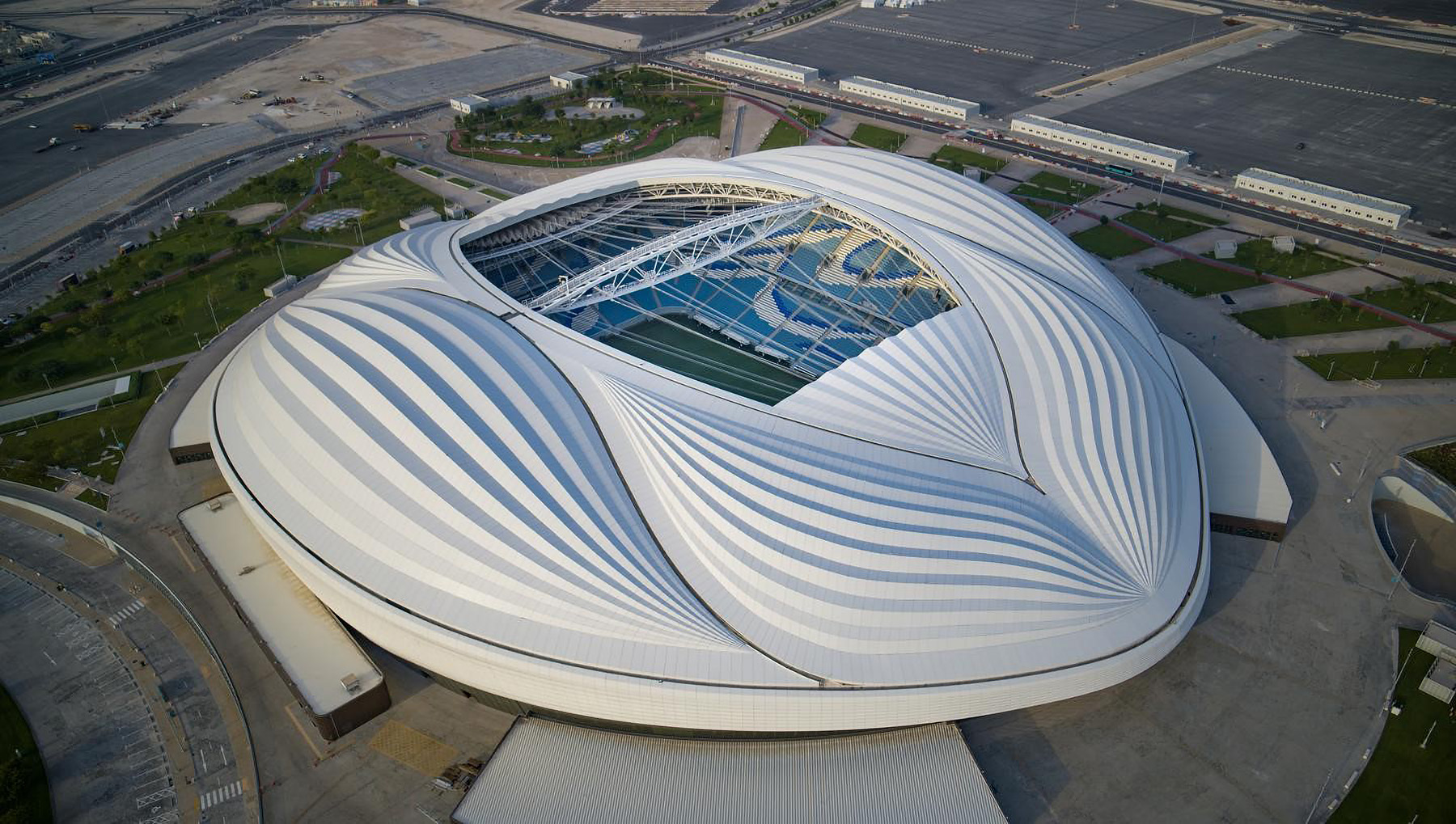 The photograph shows an aerial view of the Al Janoub Stadium roof.