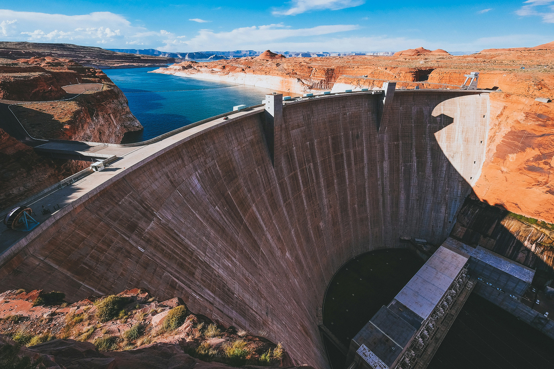 DISTANCE SHOT OF A LARGE DAM AND THE RESERVOIR BEHIND IT