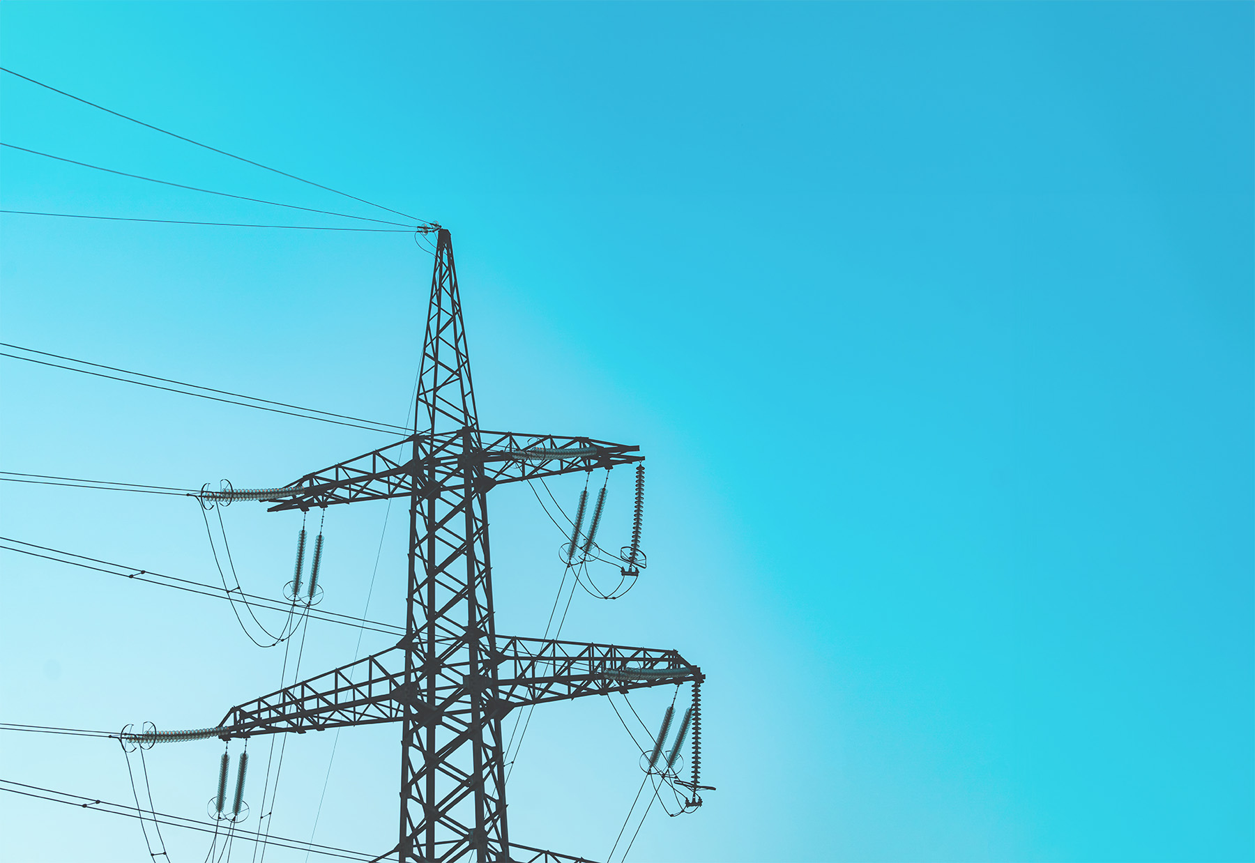 The photograph shows an electrical transmission tower.