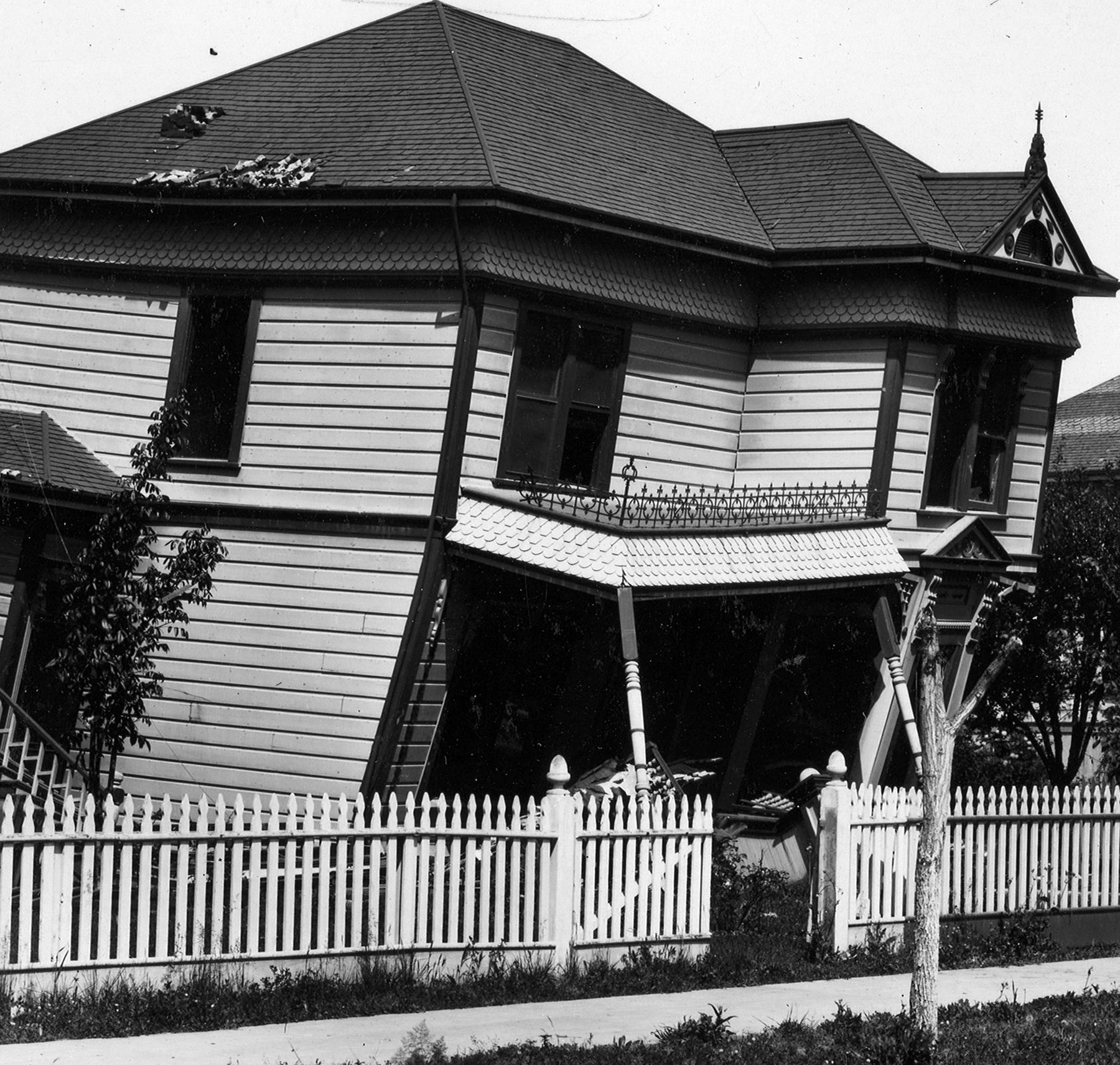 black and white photo of a collapsing house