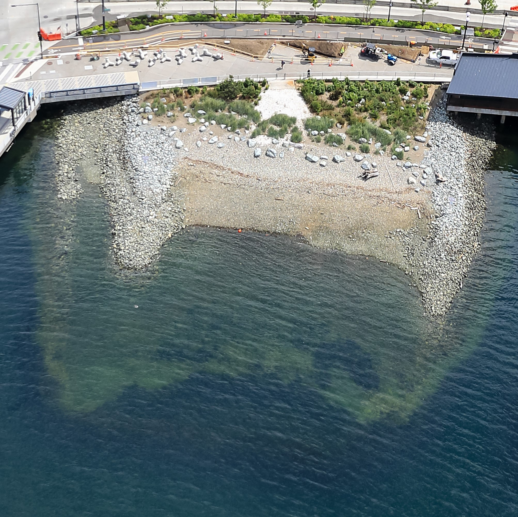 aerial overview of a rocky shoreline near a road