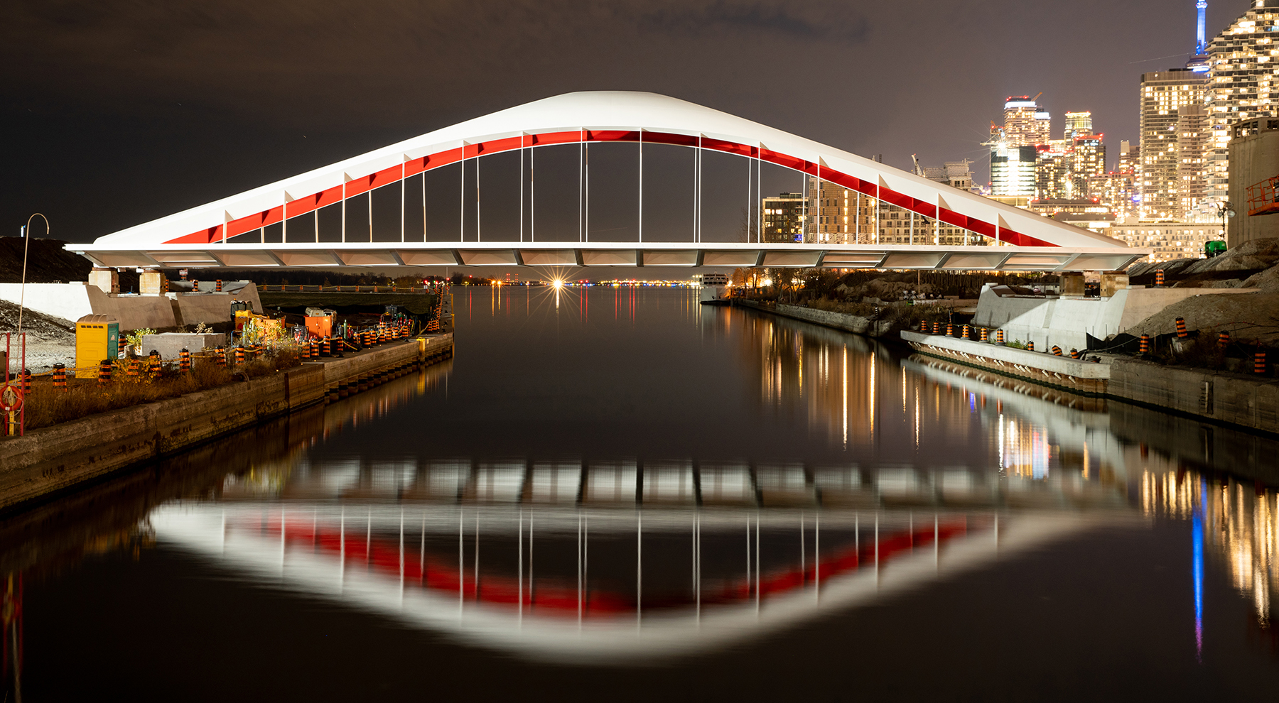 bridge at nighttime reflecting on the water below