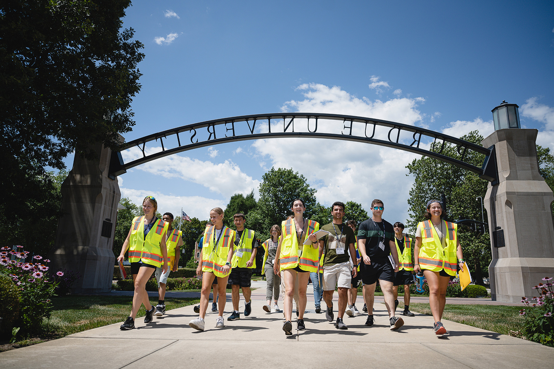 Male and female students walk toward a camera.